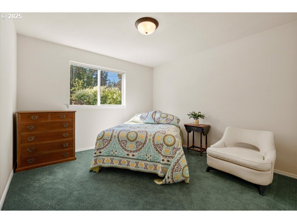21085 Arid Avenue Bend, OR 97703 - Photo 22 of 45 a bedroom with a bed and a chair