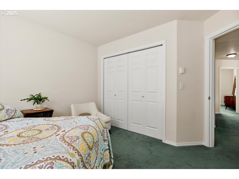 21085 Arid Avenue Bend, OR 97703 - Photo 23 of 45 a bedroom with a bed and a painting on the wall