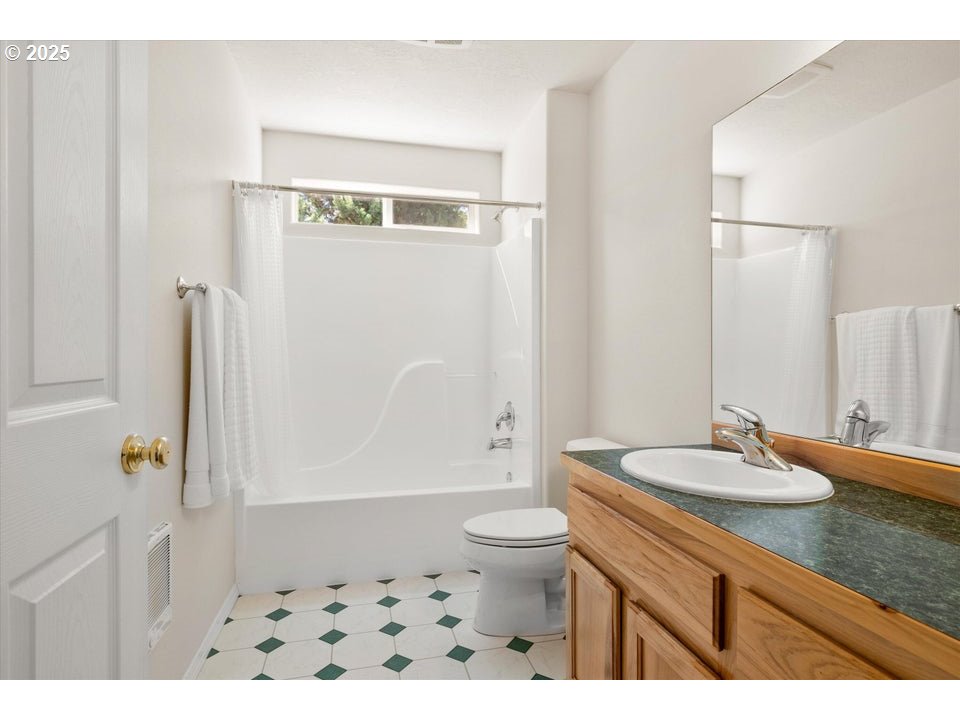 21085 Arid Avenue Bend, OR 97703 - Photo 24 of 45 a bathroom with a sink a toilet and shower