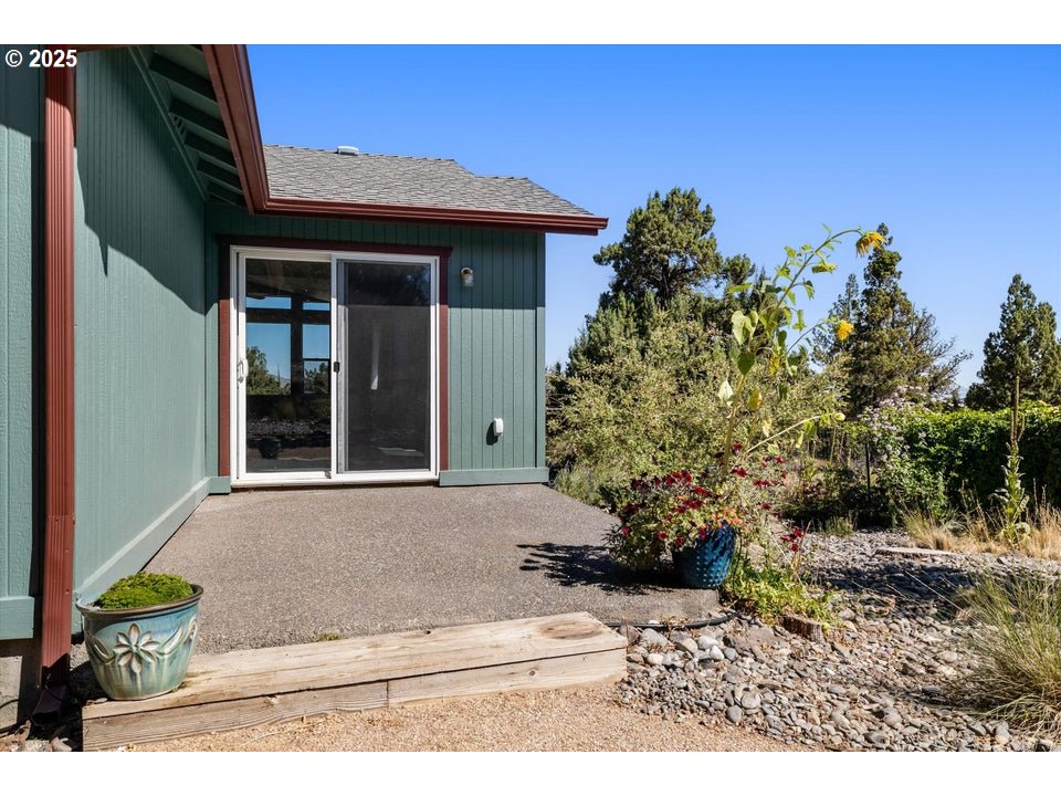 21085 Arid Avenue Bend, OR 97703 - Photo 27 of 45 a house with trees in front of it