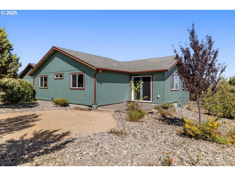 21085 Arid Avenue Bend, OR 97703 - Photo 30 of 45 a backyard of a house with large trees and wooden fence