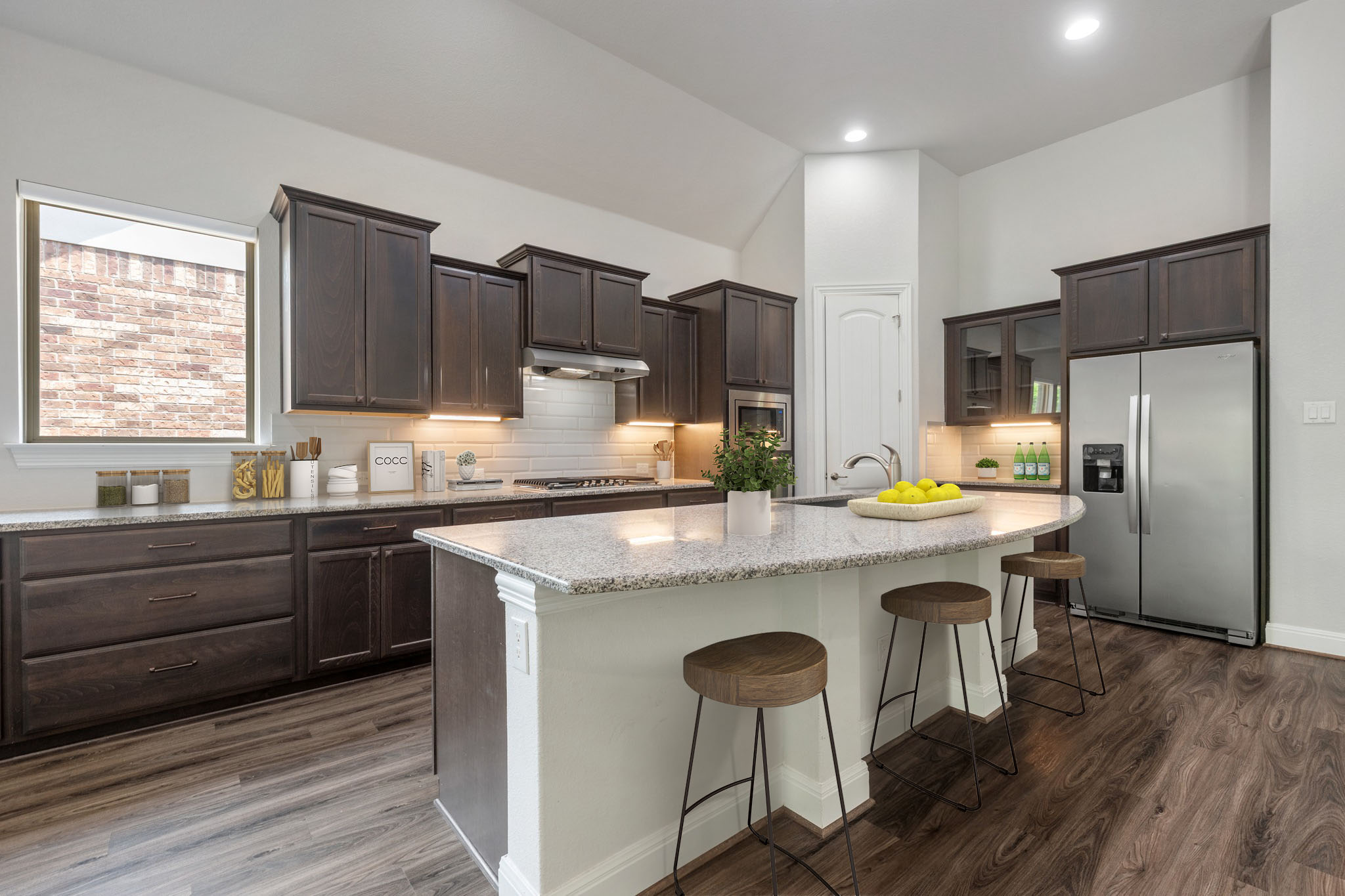 2709 Steece Way Leander, TX 78641 - Photo 12 of 39 a kitchen with kitchen island granite countertop a sink stove and refrigerator