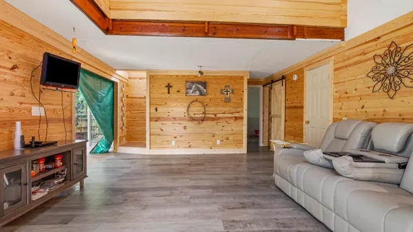 a living room with furniture and floor to ceiling windows