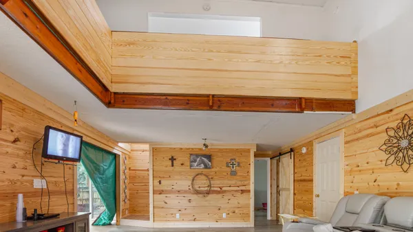a view of a livingroom with furniture and floor to ceiling window