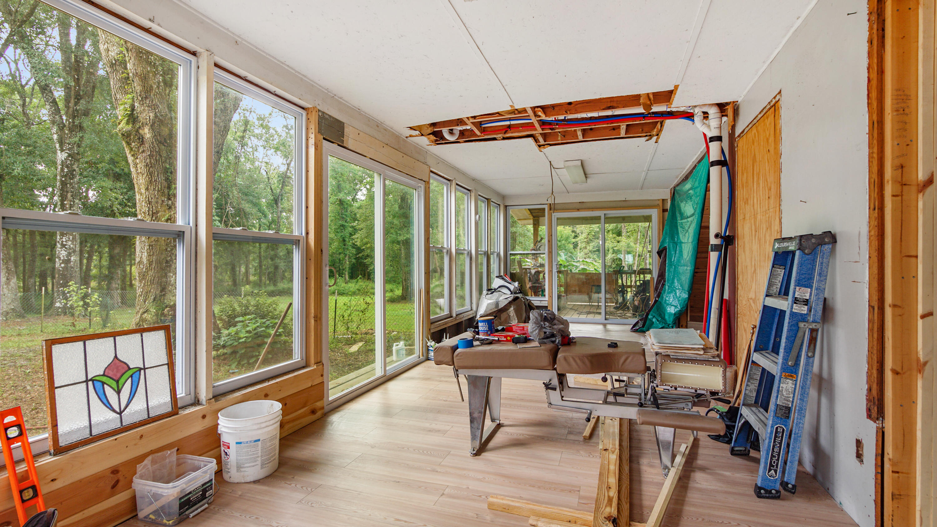 70 River Loop Road Ponce de Leon, FL 32455 - Photo 18 of 50 a living room with furniture and floor to ceiling windows
