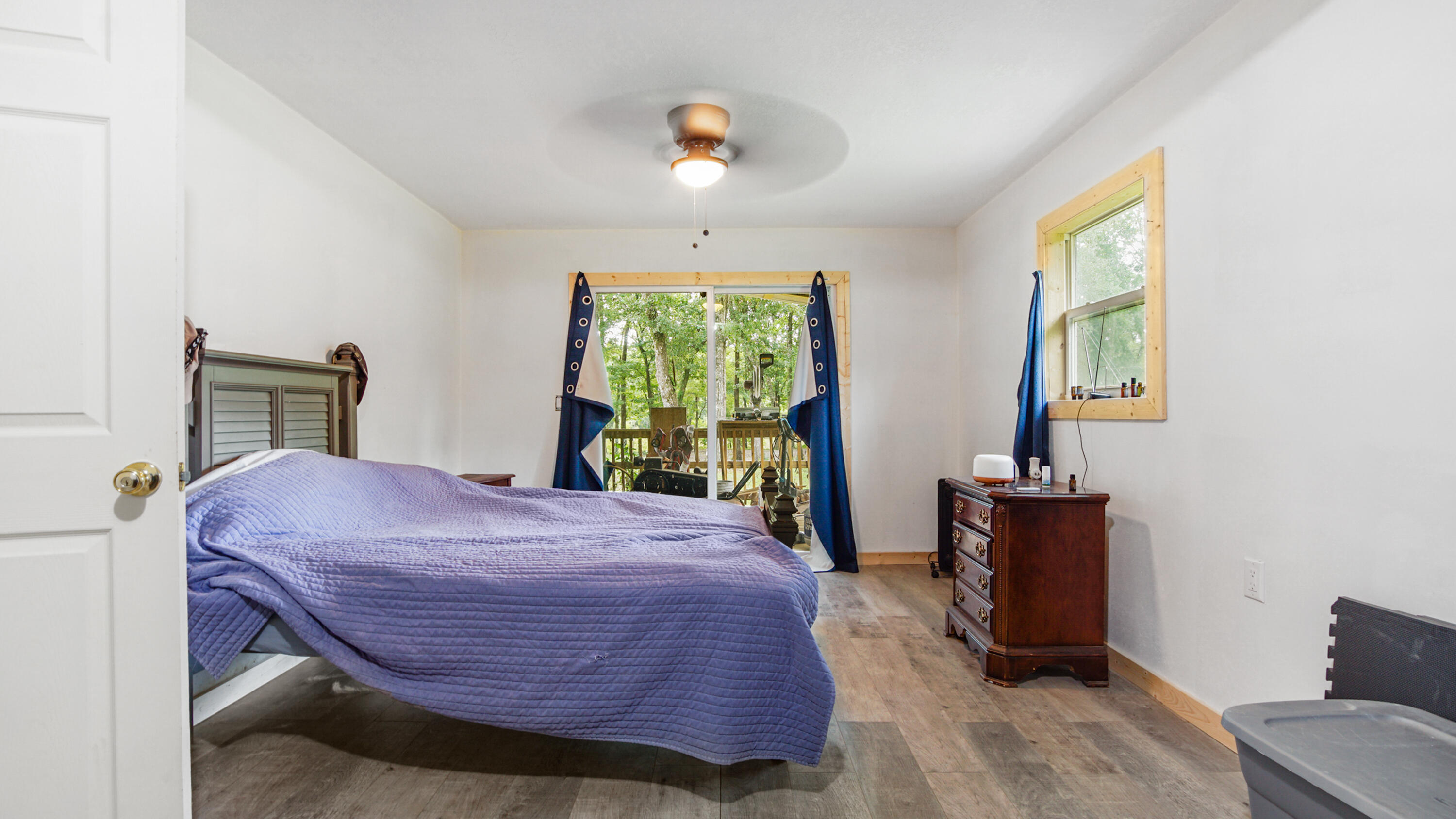 70 River Loop Road Ponce de Leon, FL 32455 - Photo 22 of 50 a bedroom with a bed and a chandelier