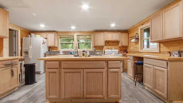 a kitchen with stainless steel appliances a sink stove and cabinets