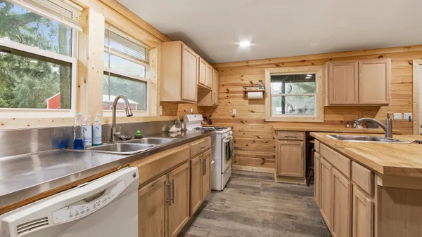 a kitchen with a sink stove and cabinets