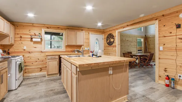 a bathroom with a granite countertop sink a mirror and shower view