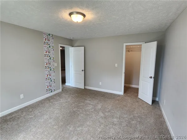 an empty room with window in bathroom