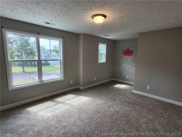 an empty room with windows and entrance