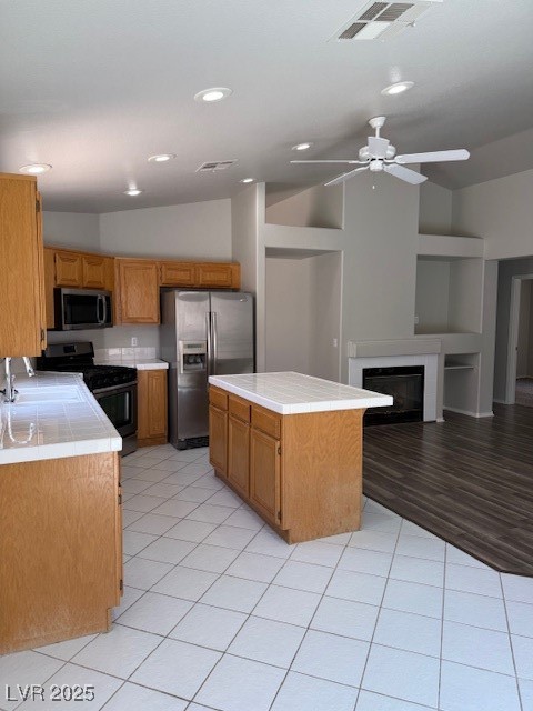 951 Country Back Road Las Vegas, NV 89123 - Photo 10 of 20 Kitchen featuring freestanding refrigerator, range, tile countertops, ceiling fan, and vaulted ceiling