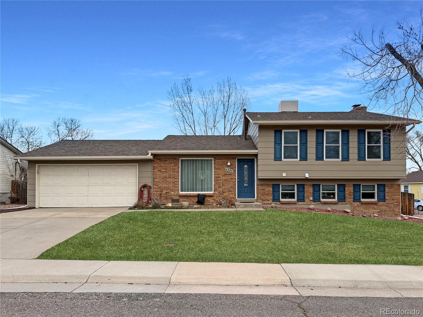 4386 South Xenophon Way Morrison, CO 80465 - Photo 1 of 38 a front view of a house with a garden and trees