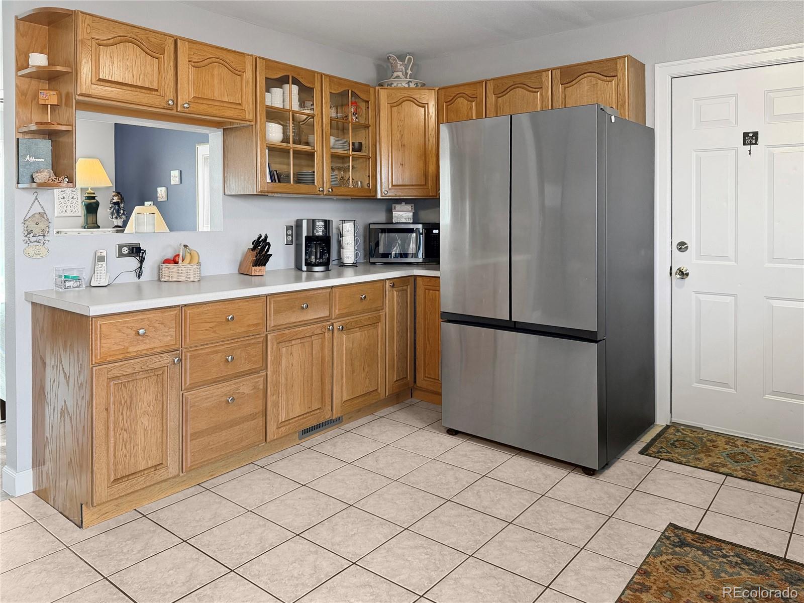 4386 South Xenophon Way Morrison, CO 80465 - Photo 11 of 38 a kitchen with stainless steel appliances granite countertop a refrigerator and a sink