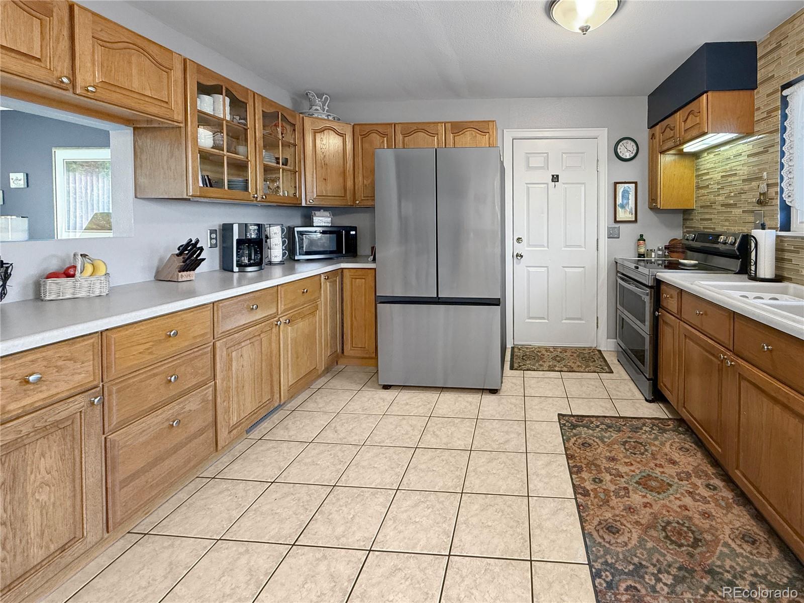 4386 South Xenophon Way Morrison, CO 80465 - Photo 12 of 38 a kitchen with stainless steel appliances granite countertop a refrigerator sink and cabinets