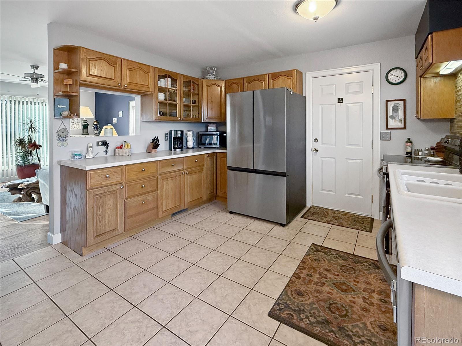 4386 South Xenophon Way Morrison, CO 80465 - Photo 13 of 38 a kitchen with stainless steel appliances granite countertop a refrigerator and a stove top oven