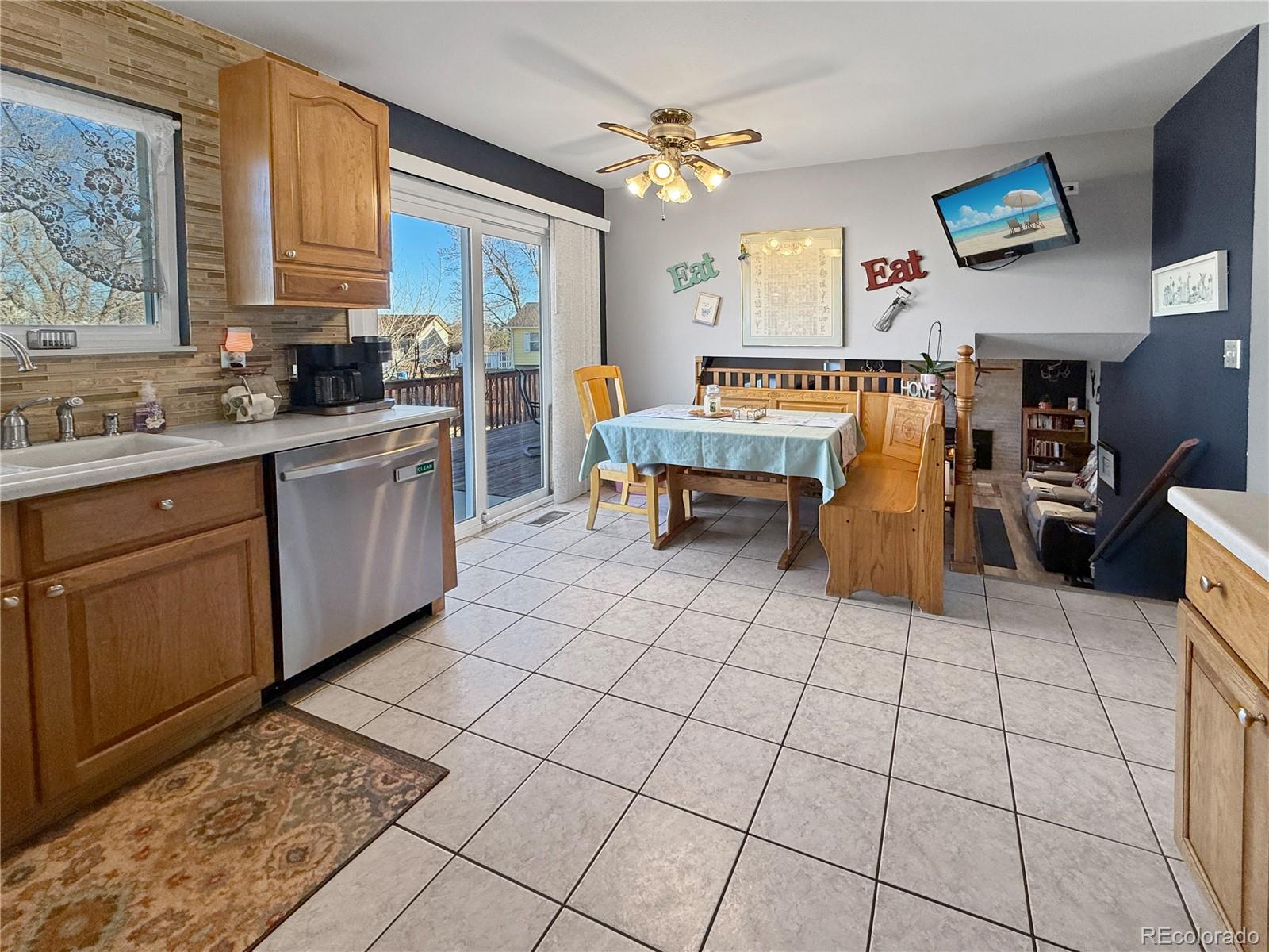 4386 South Xenophon Way Morrison, CO 80465 - Photo 14 of 38 a living room with stainless steel appliances kitchen island granite countertop a sink and cabinets