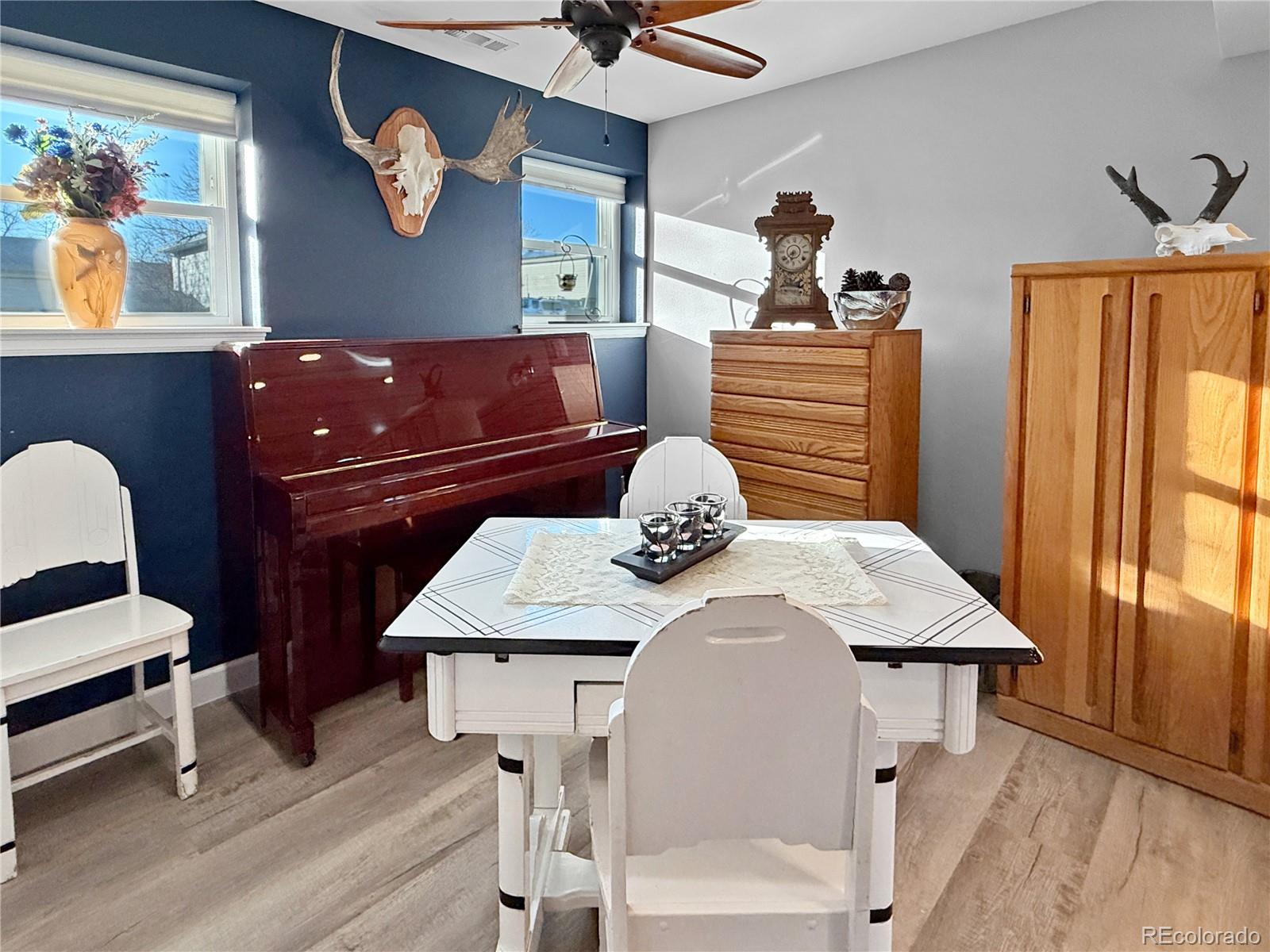4386 South Xenophon Way Morrison, CO 80465 - Photo 15 of 38 a bedroom with a bed and a chandelier
