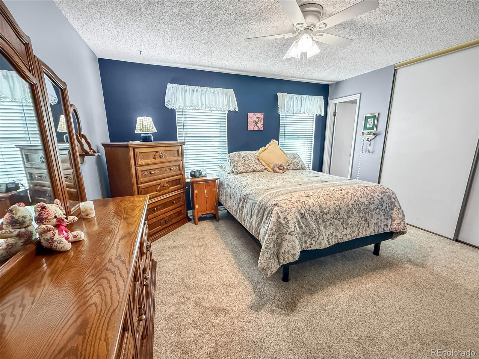 4386 South Xenophon Way Morrison, CO 80465 - Photo 17 of 38 a bedroom with a bed dresser and a window