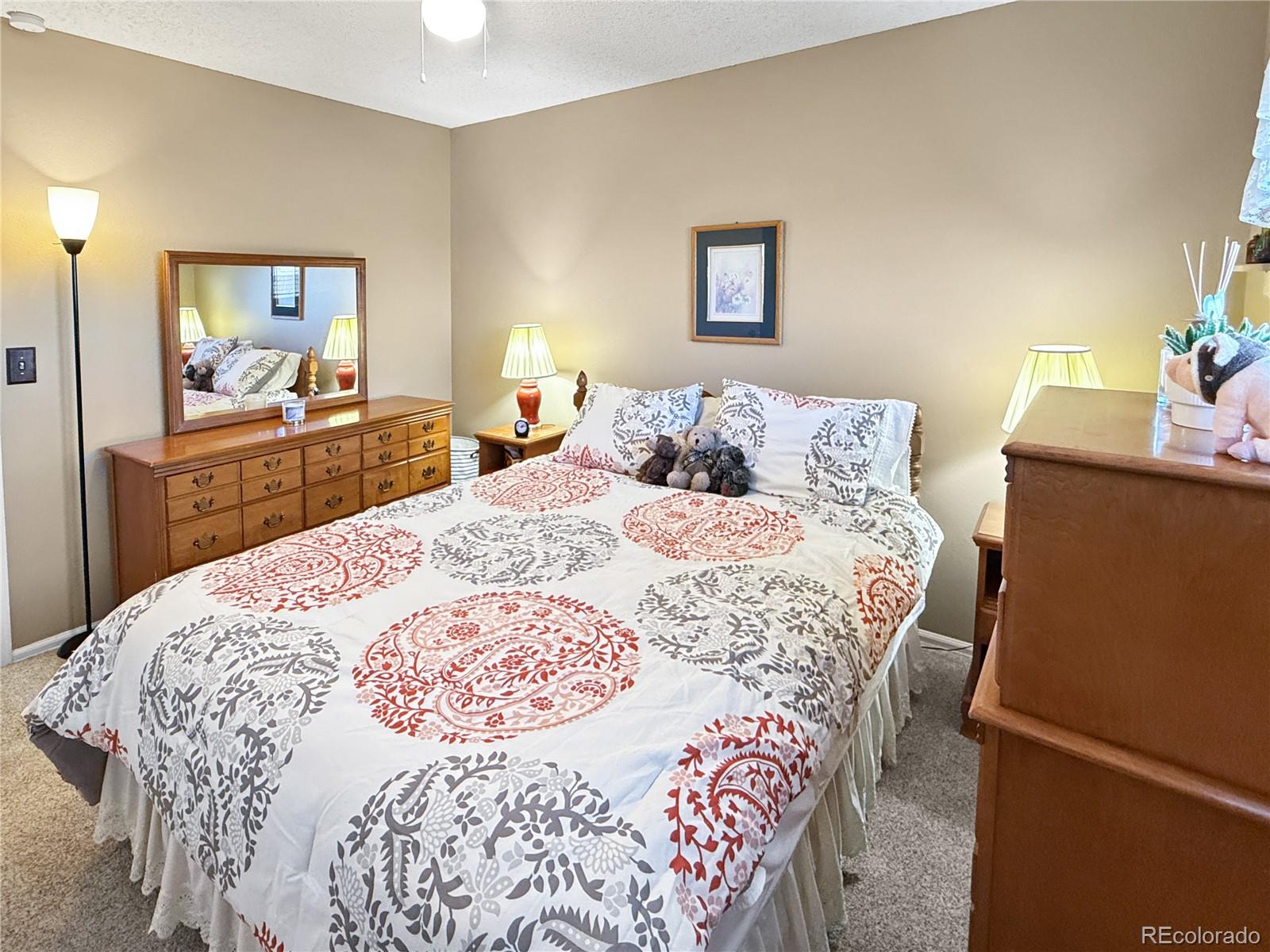 4386 South Xenophon Way Morrison, CO 80465 - Photo 20 of 38 a large bedroom with a bed and wooden floor