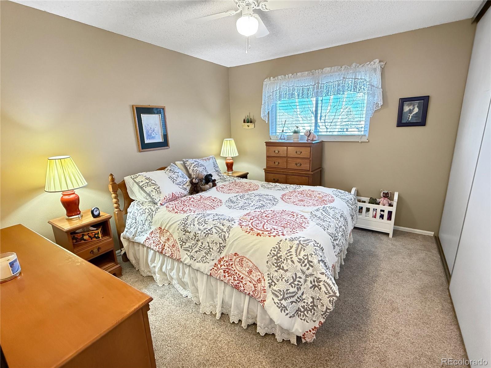 4386 South Xenophon Way Morrison, CO 80465 - Photo 21 of 38 a bedroom with double bed and a window