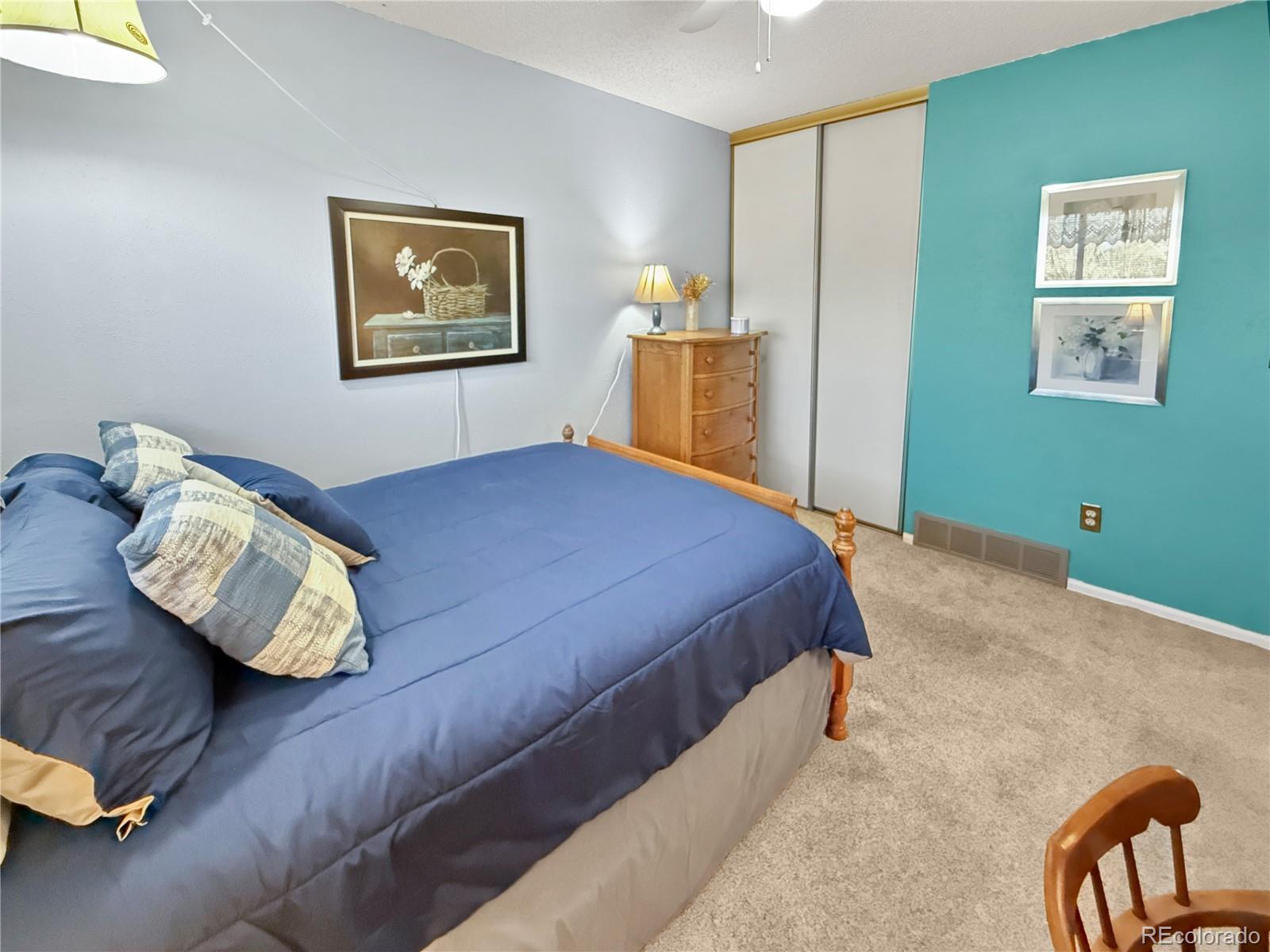 4386 South Xenophon Way Morrison, CO 80465 - Photo 22 of 38 a bedroom with a bed and wooden floor