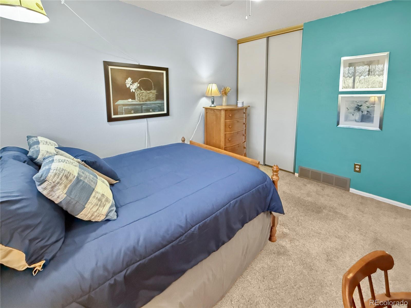 4386 South Xenophon Way Morrison, CO 80465 - Photo 24 of 38 a bedroom with a bed and wooden floor
