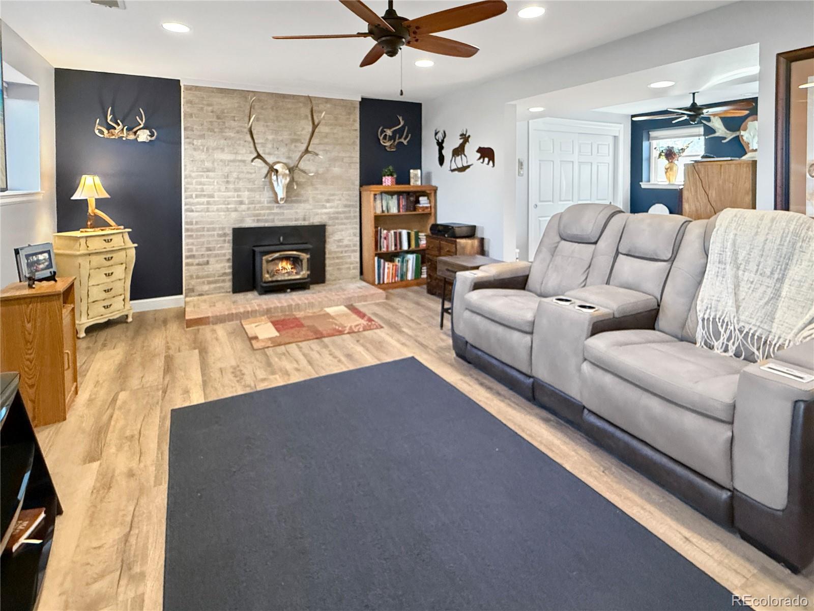 4386 South Xenophon Way Morrison, CO 80465 - Photo 6 of 38 a living room with furniture and a fireplace
