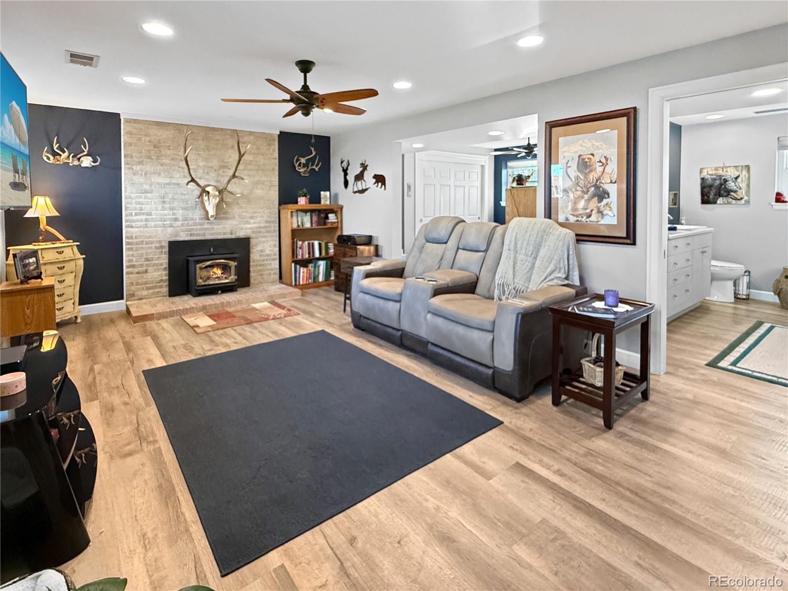 4386 South Xenophon Way Morrison, CO 80465 - Photo 7 of 38 a living room with furniture and a fireplace