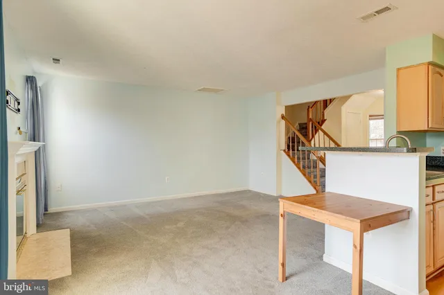a kitchen with stainless steel appliances white cabinets and a refrigerator
