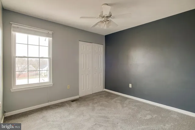a view of a house with snow on the side of a road