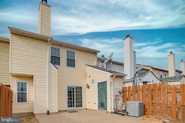 a front view of a house with a wooden fence