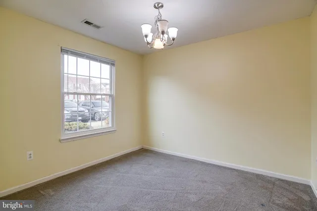 a bathroom with a granite countertop sink toilet and mirror