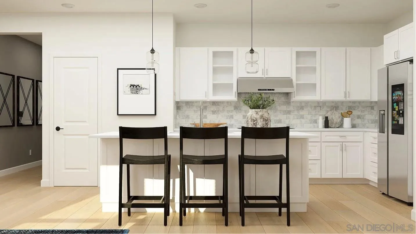 700 Metric Road San Marcos, CA 92078 - Photo 2 of 7 a kitchen with white cabinets and stainless steel appliances