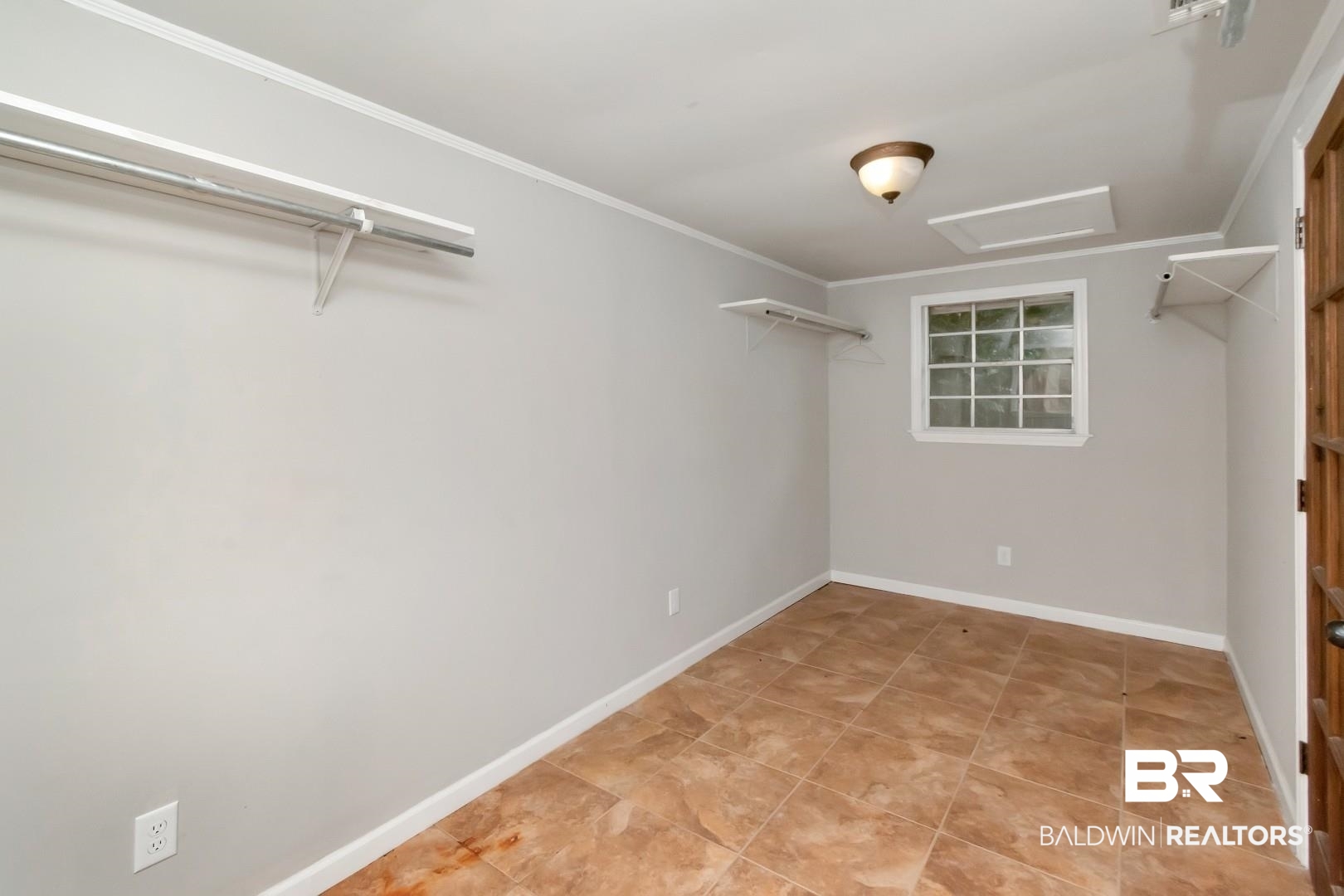 1334 Leroy Stevens Road Mobile, AL 36695 - Photo 24 of 46 Spacious closet featuring attic access and light tile patterned floors
