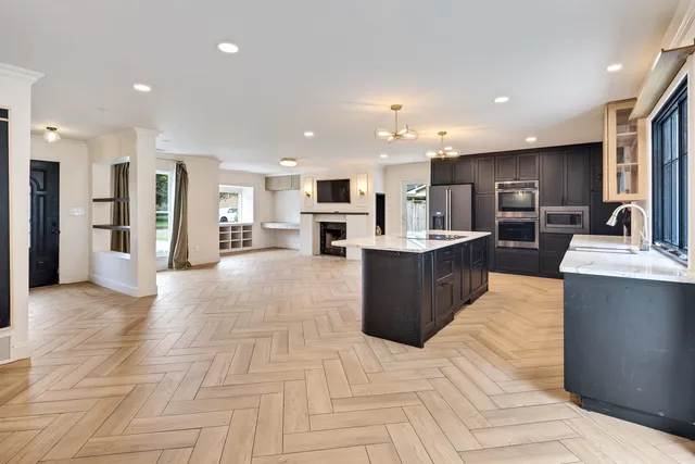 a large kitchen with stainless steel appliances lots of counter top space