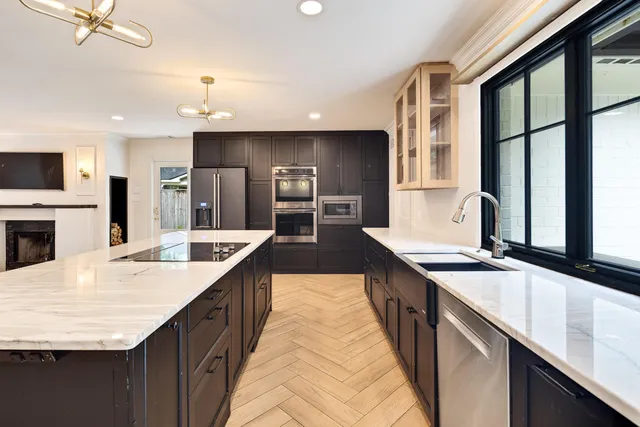 a large kitchen with granite countertop a sink and counter space