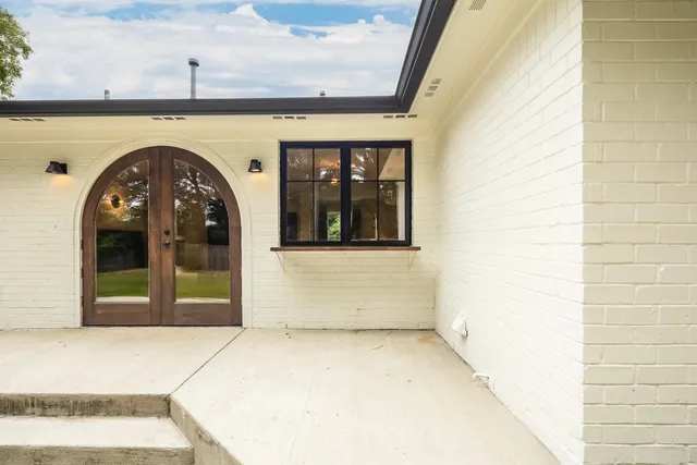 a view of a brick house with a large window
