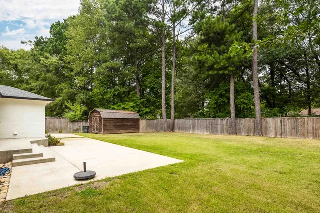 a swimming pool with outdoor seating and yard