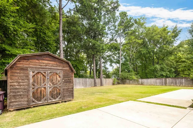 a view of swimming pool with a big yard
