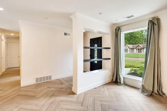 a view of a bedroom with wooden floor and a bed