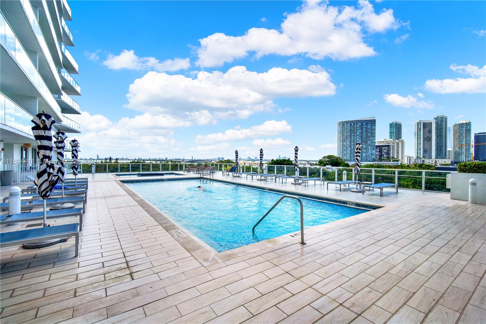 4250 Biscayne Boulevard, Unit 1607 Miami, FL 33137 - Photo 12 of 21 a view of a swimming pool with a lounge chairs