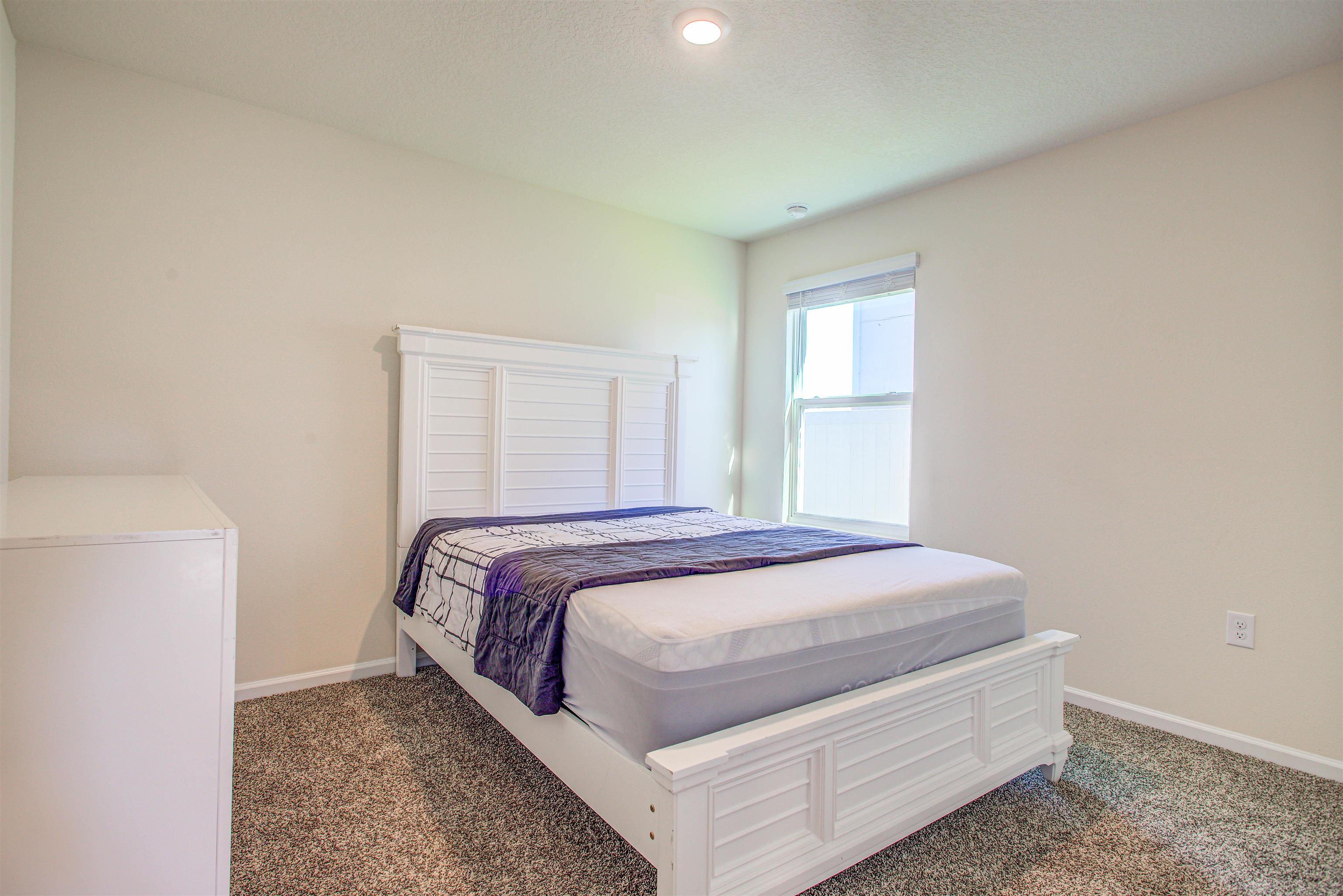 108 Albacete Road St. Augustine, FL 32084 - Photo 17 of 37 a bed sitting in a bedroom next to a window