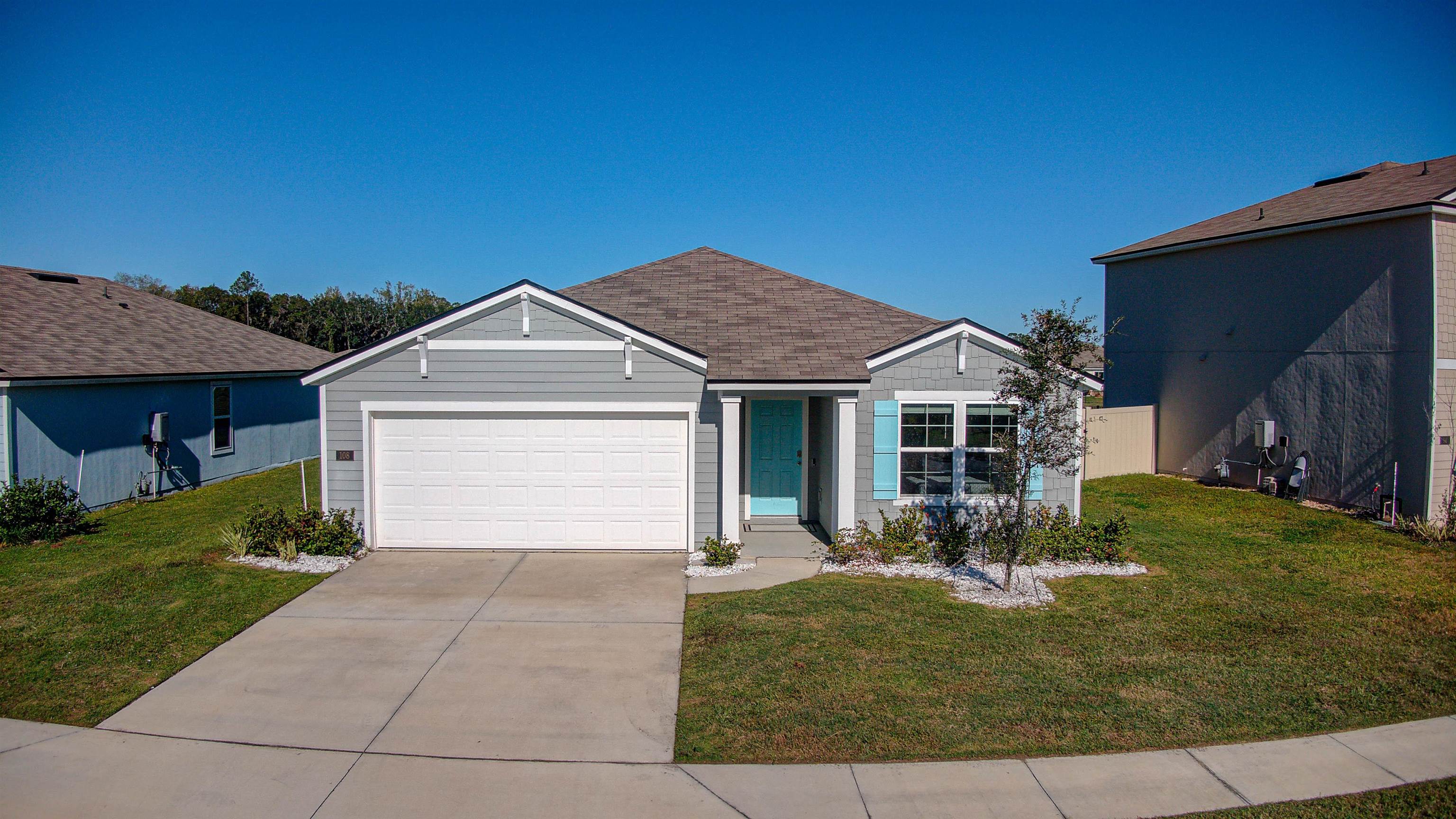108 Albacete Road St. Augustine, FL 32084 - Photo 2 of 37 a front view of a house with garden
