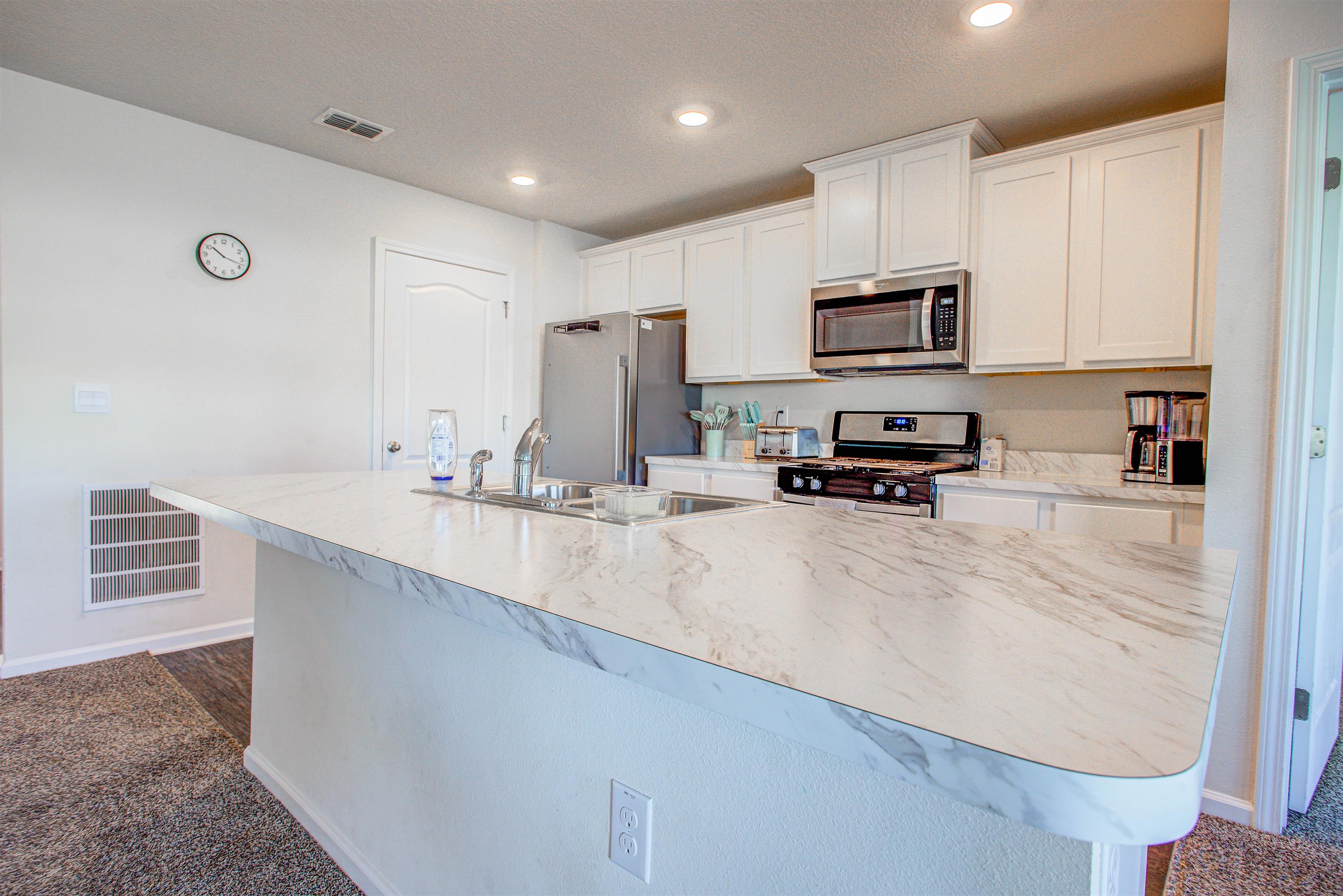 108 Albacete Road St. Augustine, FL 32084 - Photo 21 of 37 a kitchen with sink refrigerator and microwave