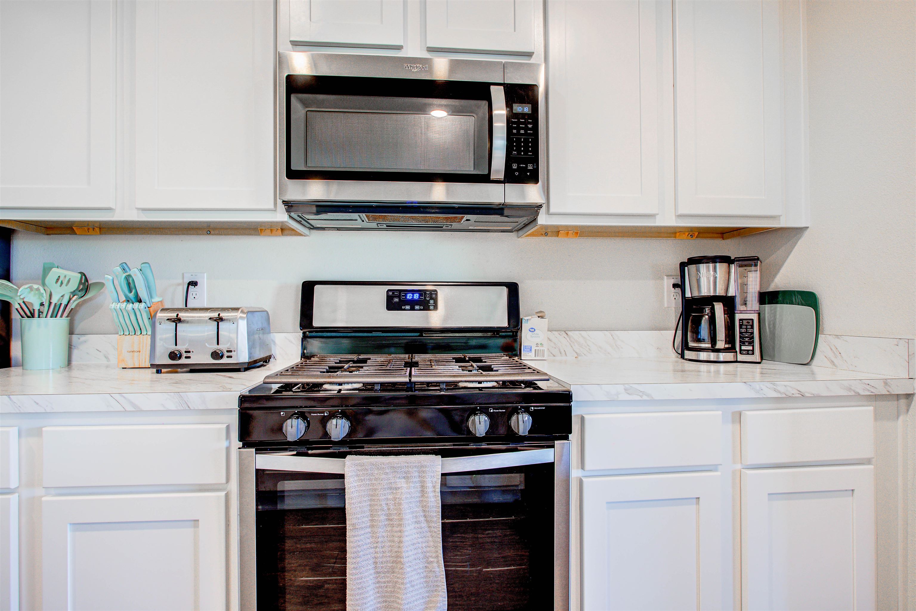 108 Albacete Road St. Augustine, FL 32084 - Photo 22 of 37 a kitchen with stainless steel appliances granite countertop a stove and a microwave