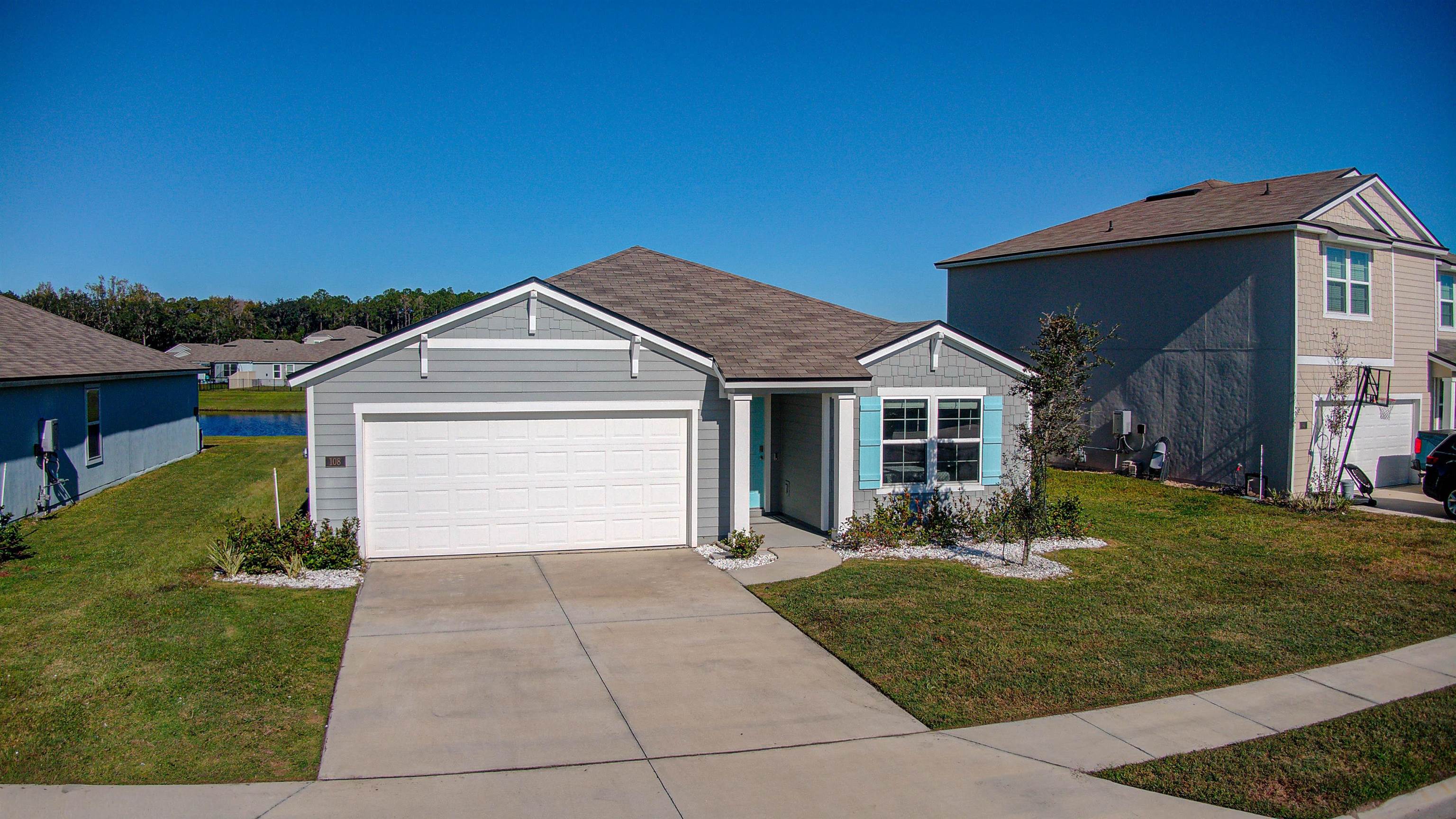 108 Albacete Road St. Augustine, FL 32084 - Photo 30 of 37 a front view of a house with a yard and garage