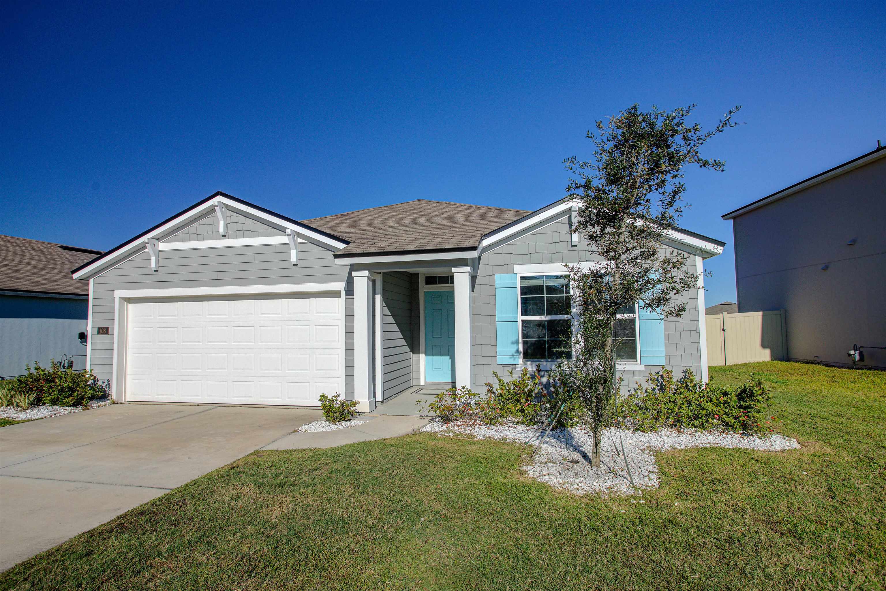 108 Albacete Road St. Augustine, FL 32084 - Photo 34 of 37 a front view of a house with a yard and garage