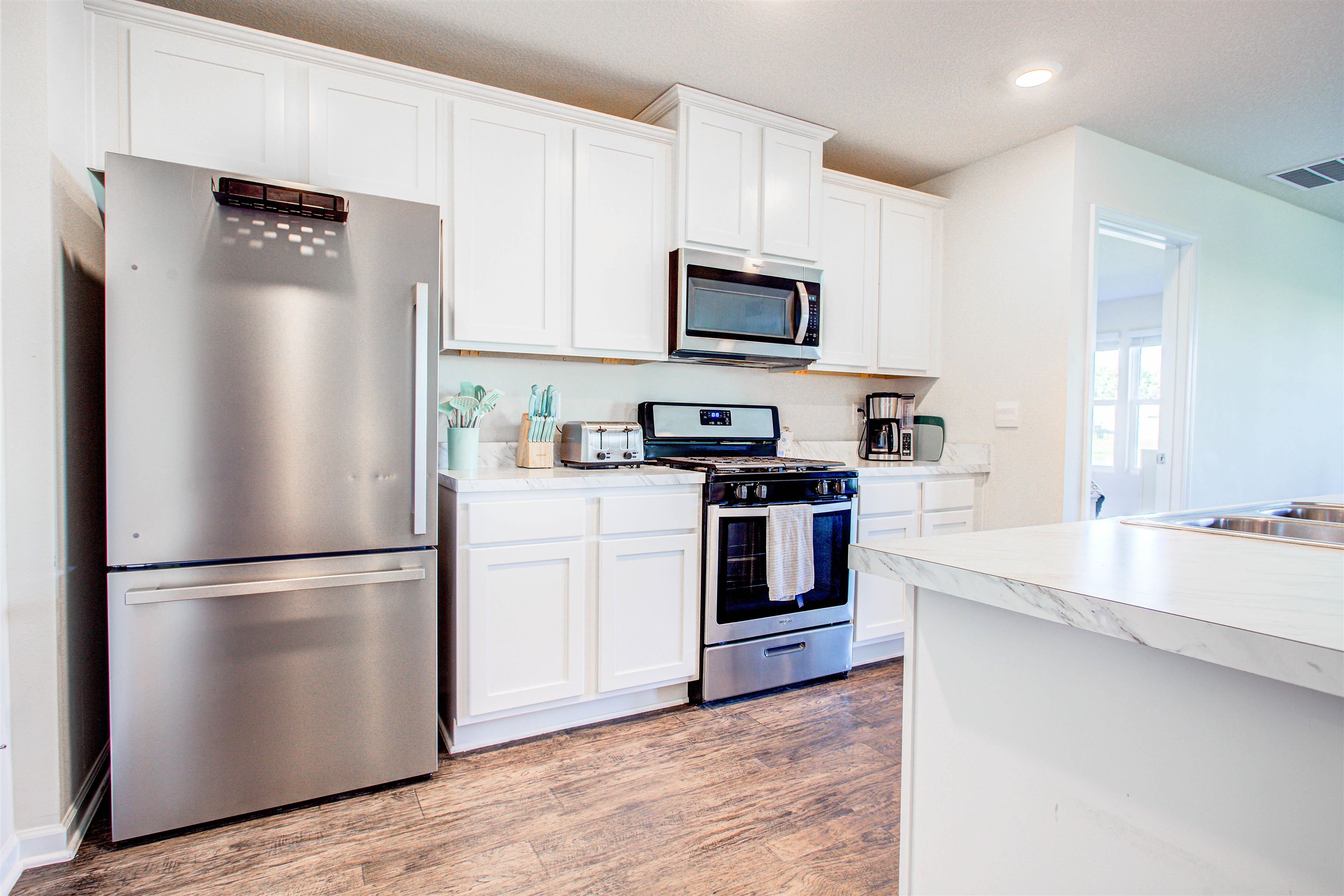 108 Albacete Road St. Augustine, FL 32084 - Photo 5 of 37 a kitchen with stainless steel appliances a refrigerator stove and microwave