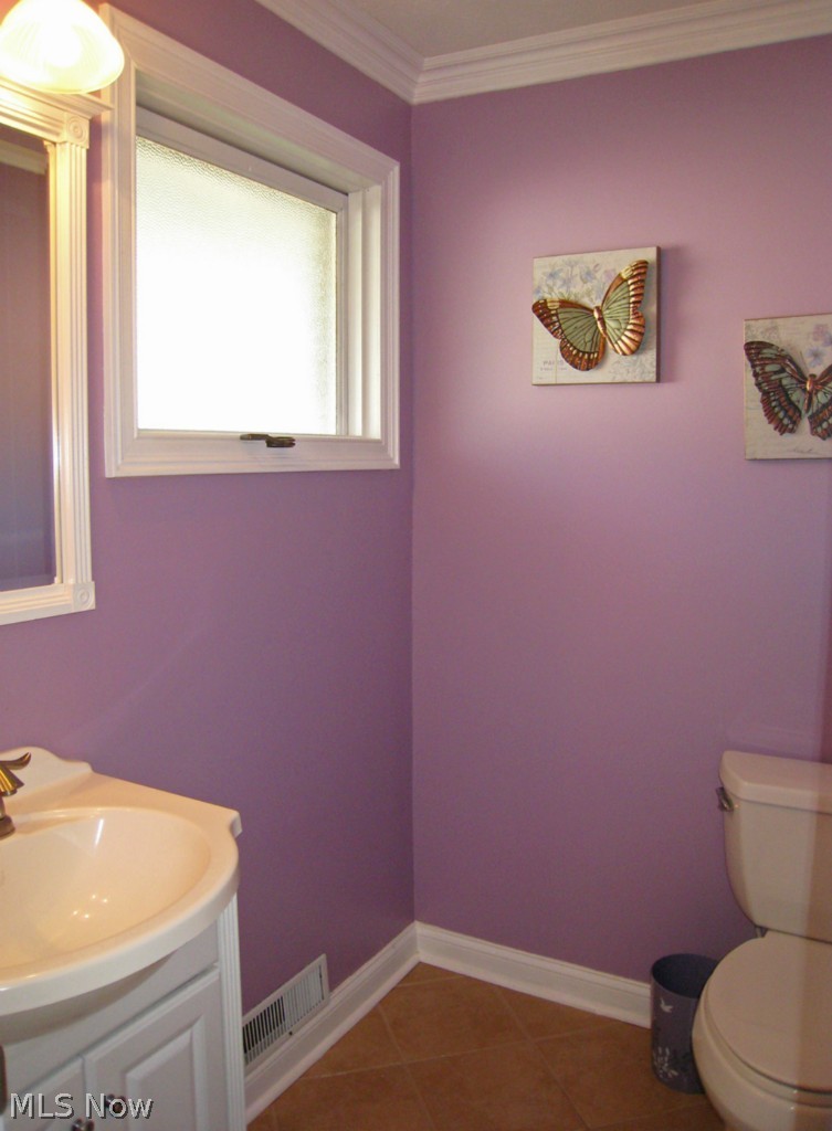 6925 Maplewood Road Parma Heights, OH 44130 - Photo 13 of 25 Half bathroom off of the kitchen. Ceramic tile.
